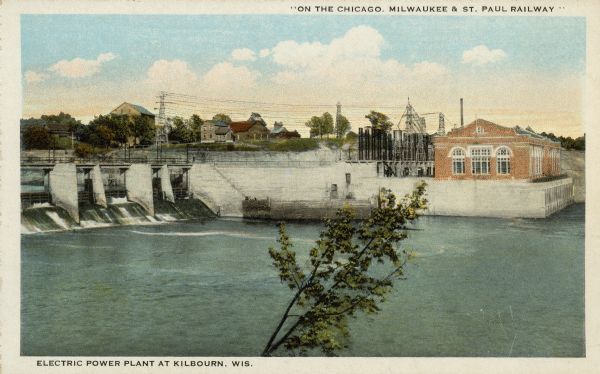 Text on front reads: "'On the Chicago, Milwaukee & St. Paul Railway.' Electric Power Plant, Kilbourn, Wis." Completed in 1909, the power plant is still in use today.<p>Kilbourn City was founded in 1857 by Byron Kilbourn, the name was changed in 1931 to Wisconsin Dells.</p>