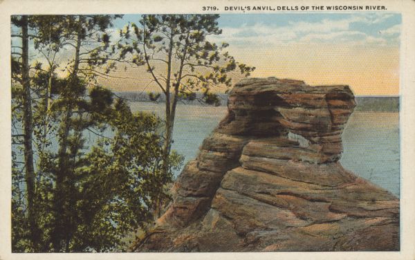 Text on front reads: "Devil's Anvil, Dells of the Wisconsin River." A rock formation and trees above the Wisconsin River. Devil's Anvil is also known as Demon's Anvil.