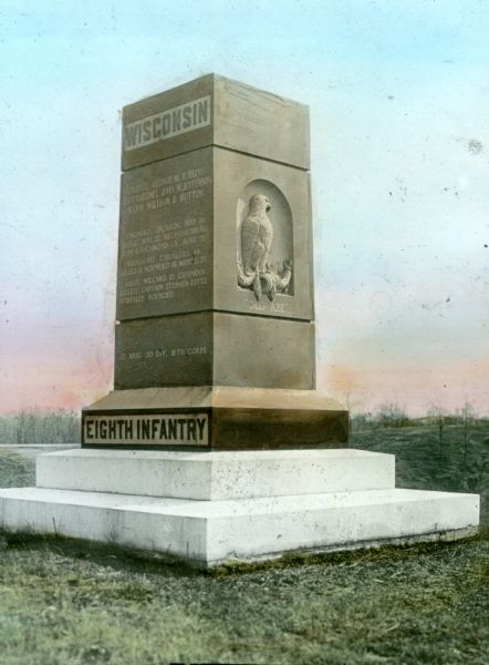 The 8th Wisconsin Infantry Regimental Marker at Vicksburg National Military Park features a sculpture of the eagle "Old Abe" on the side. The monument is made of Montello granite.