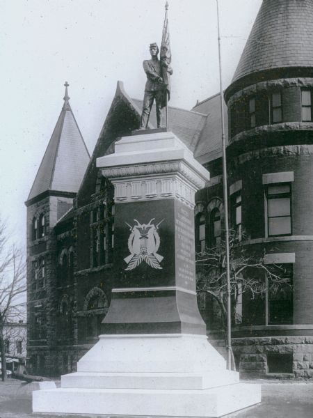 The Soldiers and Sailors Civil War Monument on the grounds of the Green County Courthouse. A sculpture of a soldier stands atop the massive base made of Montello granite. The base cost $10,000.