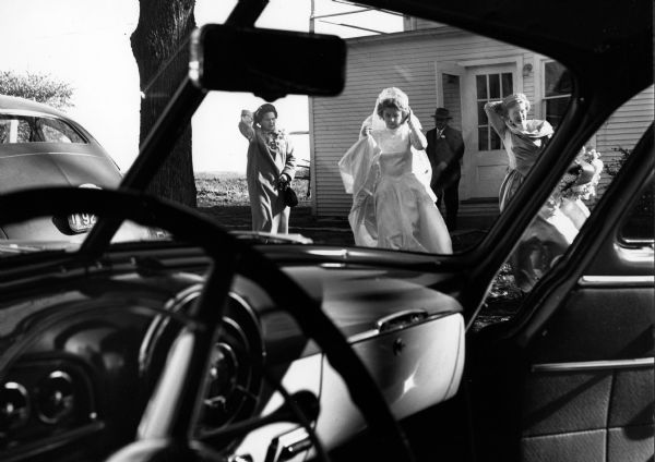 Eunice Lamers leaves for her wedding to Don Dehn. Her parents Ted and Ceil Lamers are in the background.