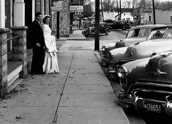The newlyweds pose in front of Krueger's Empire Hotel in Theresa.