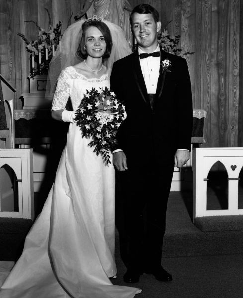 Newlyweds Jean Beck and Bruce Dudley in front of the altar.