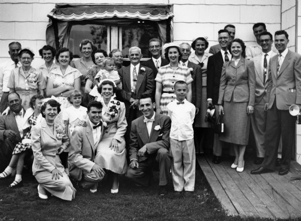Dick and Carol Ouellette pose with relatives and friends after their wedding.