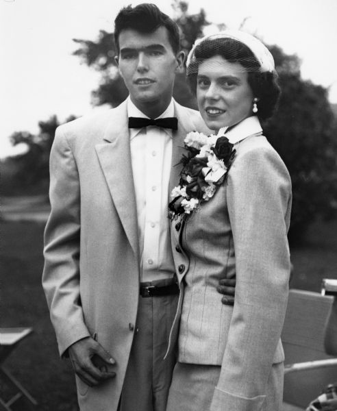 Carol Frings and Dick Ouellette pose for the photographer outside at their wedding.