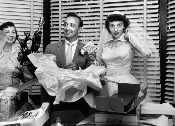 "Skip" and Marion open presents at their wedding. Hallie, sister of the groom, is at the left.