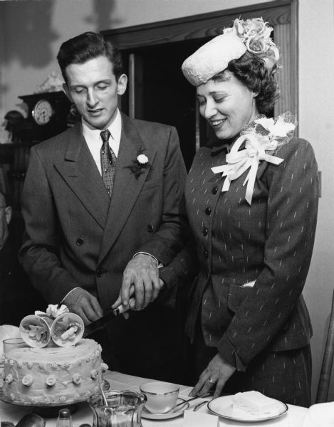 Ralph Widmer and Helen Bodden cut their wedding cake.