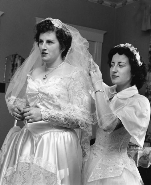 Carol Leichtle helps her friend, Patricia Bintzler, prepare for her wedding.