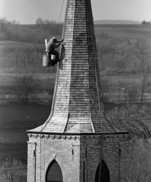 A steeplejack works on St. Peters Lutheran Church.