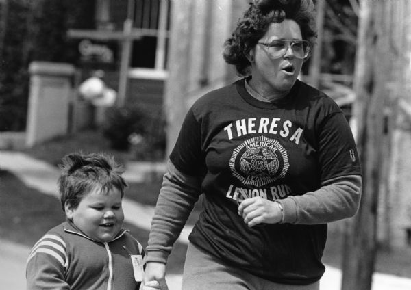 Six year-old Joey Bernhard and his aunt Sara run the Half Mile Fun Run.