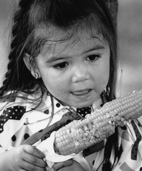Laura Rivera celebrates Appreciation Day with an ear of corn.