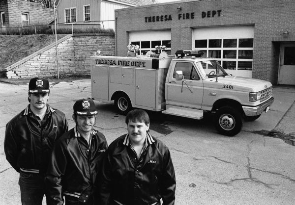 Firemen Joel Graff, Craig Hahn and Max Zastrow pose in front of the firehouse.