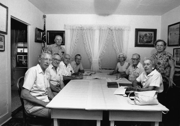 The Theresa Historical Society held a meeting at the Schiefer house. Jim Widmer, Russ Bandlow, Fred Bandlow, Les Beck, Evangeline Koll, John Bodden, and Peggy Langenfeld are seated. Standing is Lester and Evelyn Unglaub.