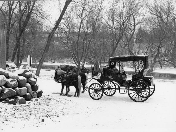 Horses and carriage at the east end of Henni Street in winter.