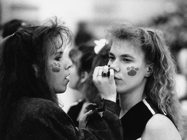 Rhonda Marks and Ami Toellner paint their faces prior to a Lomira High School girls basketball game.