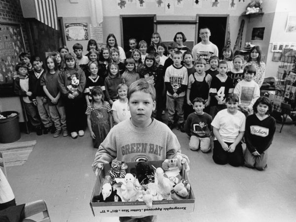 Immanuel Lutheran Church school children of rural Mayville collected 60 Beanie Babies as their December chapel offering to be given to St. Agnes Hospital in Fond du Lac. Second grader, Joe Widmer, is holding the Beanie Babies. Joe's mother, Penny Widmer, was instrumental in organizing the drive.