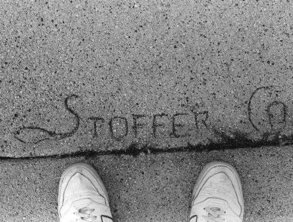 Companies that build sidewalks in Theresa branded the concrete with their names. Stoffer and Schuster's mark is pictured.