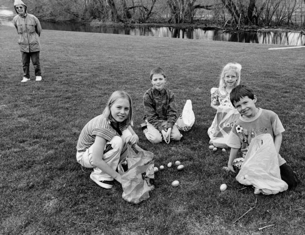 With Shirley Widmer looking on, Chelsey and Logan Wilz and Parker and Carly Hren count their Easter eggs.
