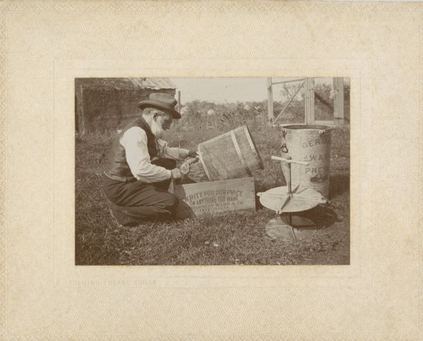 Dr. Charles C. Miller transferring bees from stump to wire container.