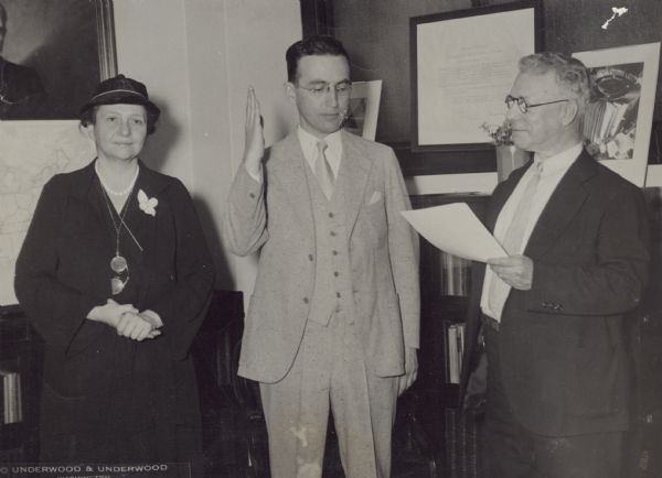 Arthur J. Altmeyer taking the oath as Assistant Secretary of Labor. Secretary of Labor Frances Perkins stands on the left, and Samuel Gompers on the right, Chief Clerk (a son of the famous President of the American Federation of Labor).