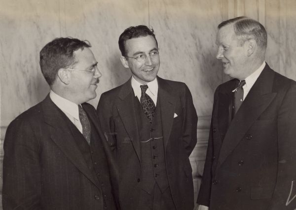 In the U.S. Supreme Court Room, after hearing the Court hand down its decisions upholding the constitutionality of the old age insurance and unemployment insurance provisions of the Social Security Act.<p>From left to right: Murray W. Latimer, Chairman of the Railroad Retirement Board; Arthur J. Altmeyer, Chairman of the Social Security Board; Frank Bane, Executive Director of the Social Security Board.