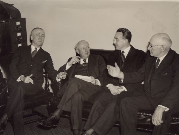 The conference concerned the pending bill to improve the Social Security Act. From left to right, all sitting: Senator James F. Byrnes, Chairman of the Senate Committee on Unemployment and Relief (later Justice of the U.S. Supreme Court and Secretary of State); Senator Pat Harrison, Chairman of the Senate Finance Committee; Arthur J. Altmeyer, Chairman of the Social Security Board; and Robert L. Doughton, Chairman of the House Ways and Means Committee.