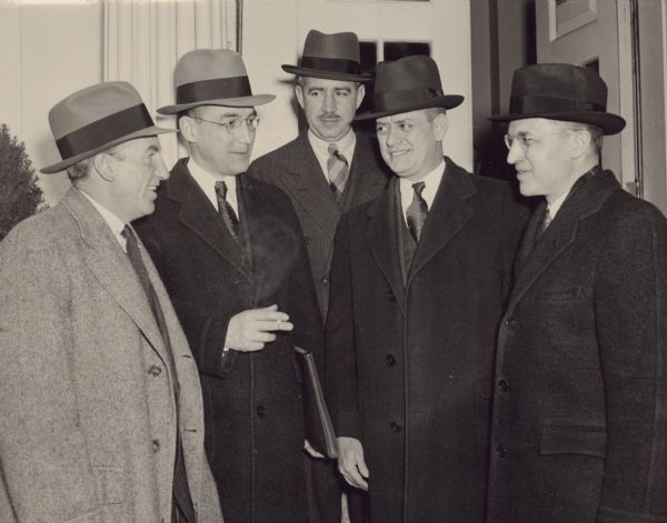 Leaving the White House after their Social Security conference with President Roosevelt are (left to right): John Hanes, Undersecretary of the Treasury; Arthur J. Altmeyer, Chairman of the Social Security Board; Marshall E. Dimock, of the Labor Department; Representative Jere Cooper and Professor Douglas Brown, of Princeton University.