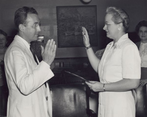 Arthur J. Altmeyer, taking the oath of office on reappointment as Chairman of the Social Security Board, Term 1945-51. Mrs. Sarah H. Napier is the Notary Public. In the background, Naomi L. D'Orsey, Maie A. Hardy, Lottie M. Newnam, and Myrtle Helma.