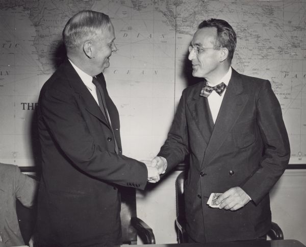 The 13th anniversary of the Social Security Act of August 14, 1935 is observed by its first Executive Director, Frank Bane, (left) now Director of the Council of State Governments, and Arthur J. Altmeyer, Commissioner, who was appointed a member of the former Social Security Board when it was formed in 1935. Both Bane and Altmeyer addressed staff members of the Social Security Administration this week at Federal Security Agency headquarters in Washington, D.C.