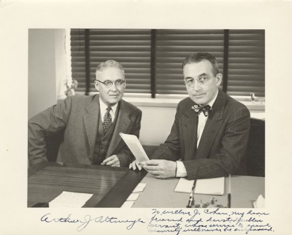 William Mitchell, Deputy Commissioner, on the left, with Arthur J. Altmeyer. This was Altmeyer's last day as Commissioner of Social Security. The photograph is signed by Arthur Altmeyer with an inscription to Wilbur Cohen, "To Wilbur J. Cohen, my dear friend and devoted public servant whose service to social security will never be surpassed."