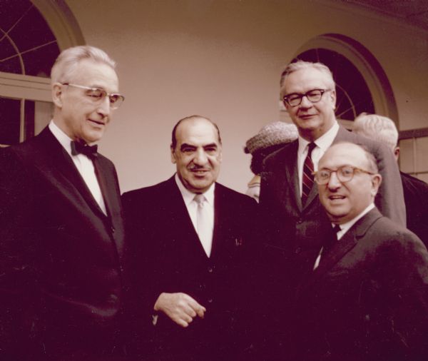 Four men, all administrators at the Social Security office, celebrating at the 20 millionth beneficiary party. They are, from left to right, Arthur Altmeyer, Anthony Celebrezze, Robert M. Ball, Commissioner of Social Security, and Wilbur J. Cohen.