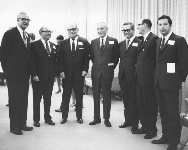 Group of men posing at a ceremony celebrating the 33rd anniversary of the Social Security bill. From left to right: Commissioner of Social Security, Robert Ball; Secretary of Health, Education and Welfare, Wilbur Cohen; Dr. Ignacio Morones-Prieto, Director, Mexican Social Security System and President, Inter-American Social Security Permanent Committee; Dr. Arthur Altmeyer; Dr. Gaston Novello, Mexico, Secretary General, Inter-American Social Security Permanent Committee; Berryl Frank, Organization of American States; Dr. Luis Garcia Cardenas, Technical Advisor.