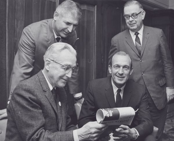 Arthur J. Altmeyer, sitting, with Mr. Hendricks, Jim MacMurray and Byron E. Goetz, all Regional Commissioners of Social Security, at a meeting.