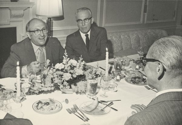 Wilbur Cohen and Arthur Altmeyer sit across the dinner table from John J. Corwin. All three men worked in U.S. Social Security Administration at different times during those thirty-five years.