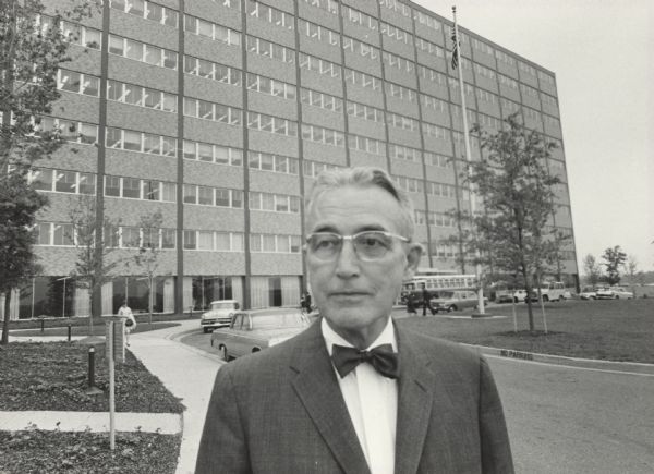 Arthur J. Altmeyer standing in front of the Social Security Administration Headquarters. In 1973 the building was renamed the Altmeyer Building in his honor.