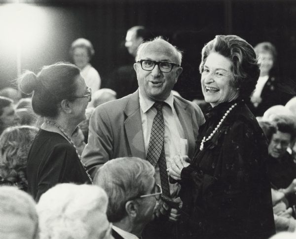 From left to right: Eloise Cohen, Wilbur Cohen and Ladybird Johnson are laughing during an event. Wilbur Cohen was a research assistant with the committee which drafted the Social Security Act in 1934. He maintained an expertise and enthusiasm for public welfare throughout his career. He became Assistant Secretary for Legislation of Health, Education and Welfare in 1961. In 1965, President Lyndon B. Johnson promoted him to Under Secretary. In 1968, Cohen became the U.S. Secretary of Health, Education and Welfare.