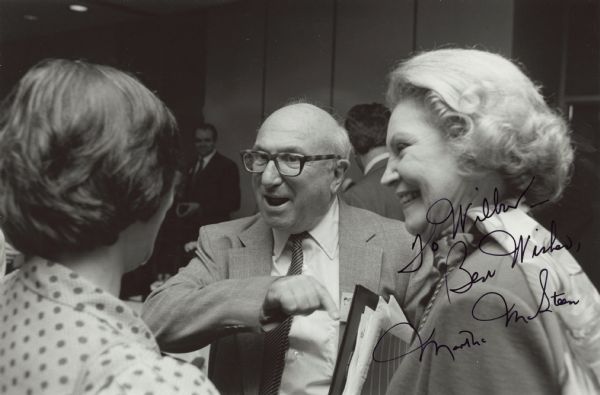 Wilbur Cohen and Rosalynn Carter talk animatedly with a woman. This photograph is dedicated to Wilbur by Martha McSteen, the Dallas Regional Commissioner for Social Security. Wilbur Cohen was a research assistant with the committee which drafted the Social Security Act in 1934. He maintained an expertise and enthusiasm for public welfare throughout his career. He became Assistant Secretary for Legislation of Health, Education and Welfare in 1961. In 1965, President Lyndon B. Johnson promoted him to Under Secretary. In 1968, Cohen became the U.S. Secretary of Health, Education and Welfare.