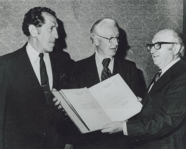 The First Distinguished Citizen Award of the National Consumers League was given to Nelson H. Cruikshank, president of the American Federation of Labor (AFL-CIO) National Council of Senior Citizens, "for his outstanding leadership in the causes of health, labor and social security." Cruikshank, center, is congratulated by the league's board chairman Robert R. Nathan, left, and former Health, Education and Welfare Sec. Wilbur J. Cohen. Cruikshank is a former director of the AFL-CIO Dept. of Social Security.