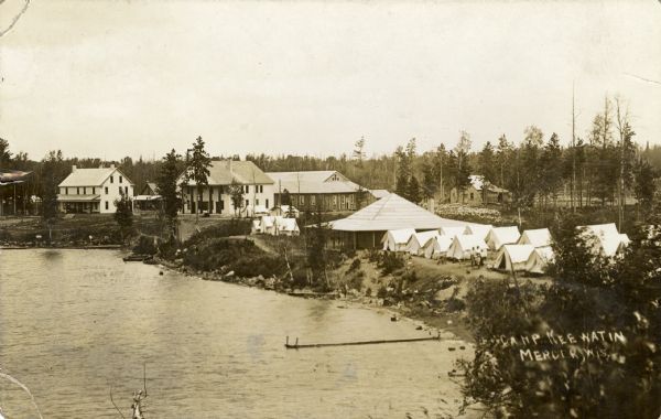 Elevated view of the camp along a lake.