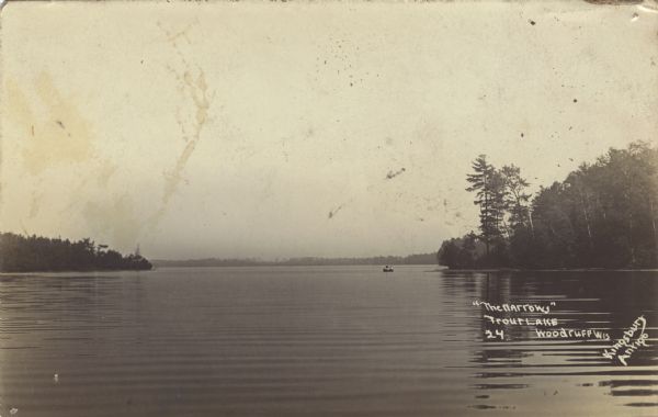 View across water of The Narrows in Trout Lake. There are people in a canoe out on the lake.<p>The postcard is from C.L. (Neal) Harrington to Alice Harrington, Hurley, Wisconsin. The text says:<p>"Dear Everybody: Arrived and found them OK. Save card. I hope mother is feeling good now. I am fine. Send mail to [blank]. The new man is young and OK. Nice place this. Neal."