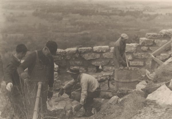 Four men are building the wall at Signal Point Lookout in Wyalusing State Park. They are part of Works Progress Administration (WPA) Project #8656-8.

The man pictured on the far left is most likely Harvard Peterson, who was foreman of the CCC crew there at the time. The park was
first known at Nelson Dewey St Park and was later changed to Wyalusing.

