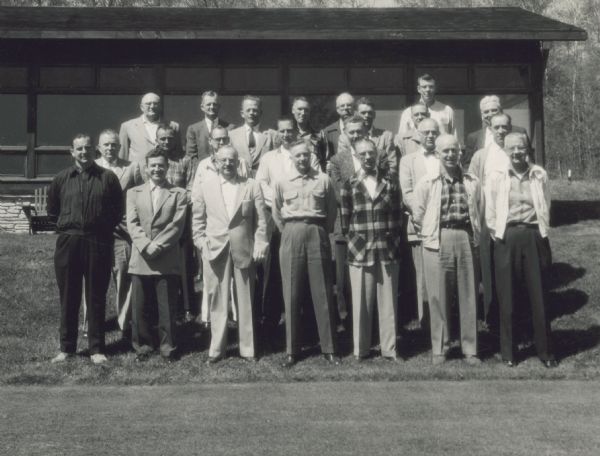 Group portrait of men standing on a lawn in front of a building. C.L. (Neal) Harrington is in the third row on the right end. The meeting was held in Peninsula State Park in Door County from May 19-21.