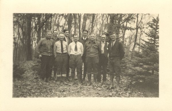 Christmas photographic postcard to C.L. Harrington from: David Wedgwood, Ben King, Marvin F Hartman, Bryan W. Brewer, Joseph L. Young, Bill Fischer, Jim Davis, C.D. Breitzke. The group is posing outdoors in Nelson Dewey State Park. It became Wyalusing State Park in 1937.