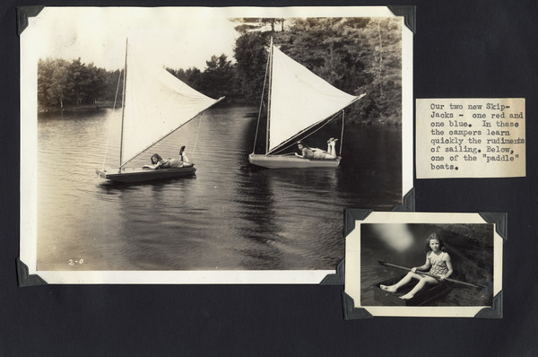 Page from Joy Camps photo album displaying two photographs with caption. The larger photograph shows two of the camp's Skip-Jack boats, each with a camper on board. The smaller photograph shows a young camper in what is labeled a "paddle" boat in the caption. Original caption notes: "Our two new Skip-Jacks--one red and one blue. In these the campers learn quickly the rudiments of sailing."