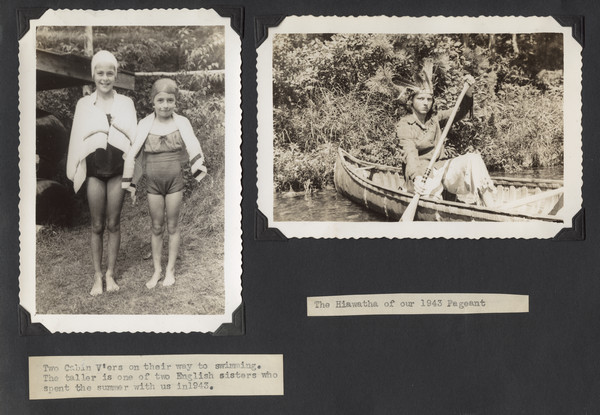 Page from Joy Camps photo album displaying two photographs. In one, two young campers wearing swimming caps, bathing suits, and towels stand in a grassy area. Original caption notes: "Two Cabin V'ers on their way to swimming. The taller is one of two English sisters who spent the summer with us in 1943." In the other photograph a camper sits in a birch bark canoe at the shoreline, dressed in costume. Original caption notes: "The Hiawatha of our 1943 pageant."