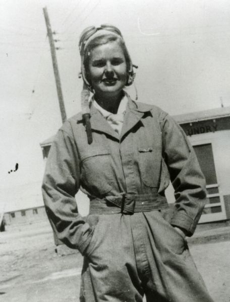Informal outdoor portrait of Dorothy Mosher wearing flying gear.