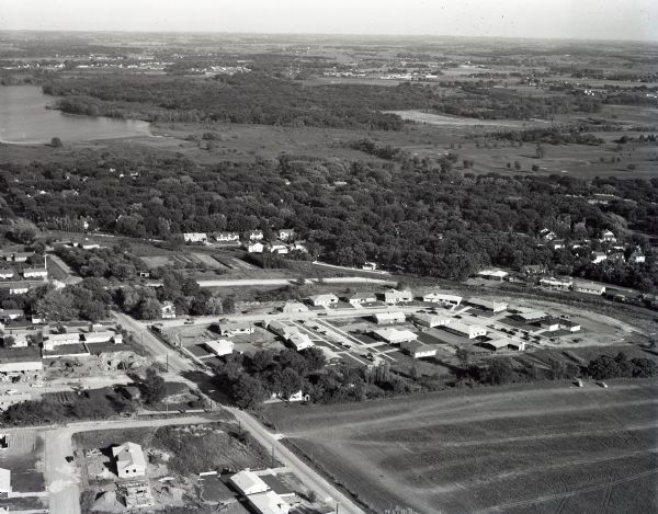 Aerial view of the west side of Madison showing newly constructed homes and homes under construction featured in the Parade of Homes. The main road through is Odana Road near the intersection with Midvale Boulevard. The view looks southeast toward Lake Wingra in the background. Rolla Lane and Somerset Lane are both visible.