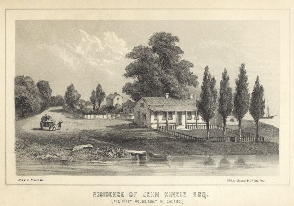Lithograhic view of the residence of John Kinzie on the bank of the Chicago River at the mouth of Lake Michigan. The residence consists of a house with a fenced yard and outbuildings behind the dwelling. A man on a road directs a horse pulling a loaded wagon at left. There is a canoe docked at a small pier on the river, and a sailboat is in the background on the right, probably on Lake Michigan.