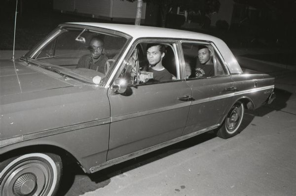 Four members of Milwaukee's NAACP Youth Council Commandoes sit in a car outside the home of Police Chief Harold Brier at 3139 S. 50th Street.