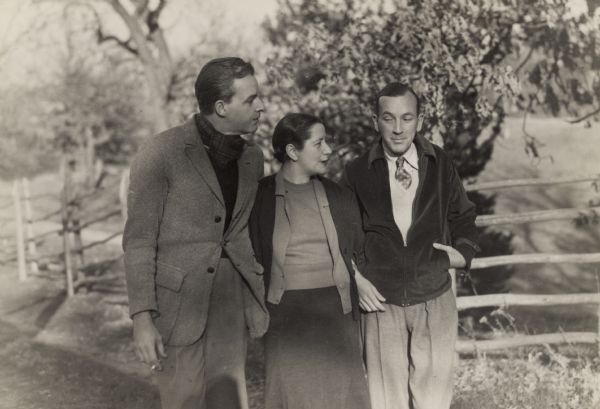 Alfred Lunt, Noel Coward, and Lynn Fontanne walking together on the Ten Chimneys property.